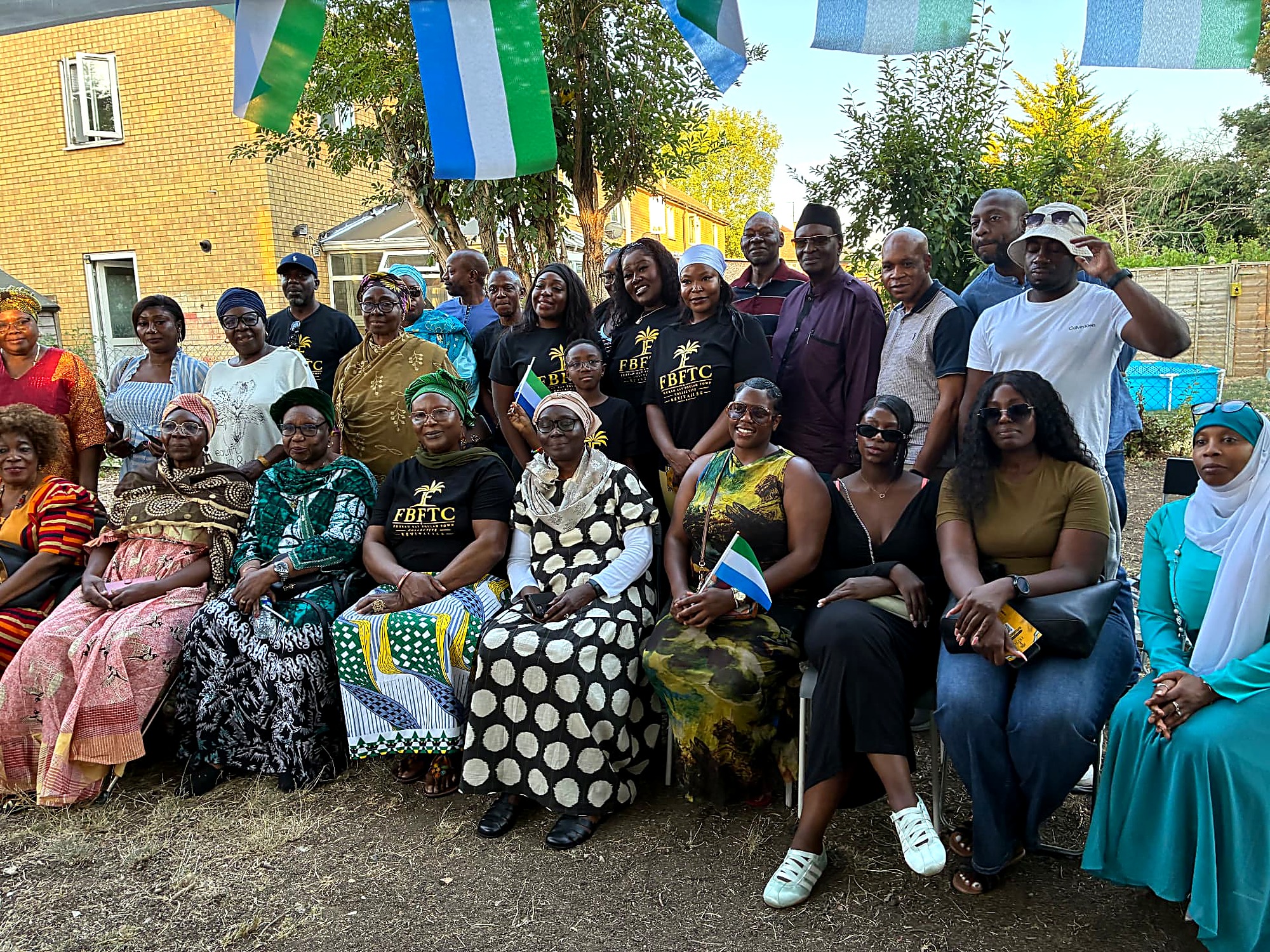 A full group photograph under the Sierra Leone flags