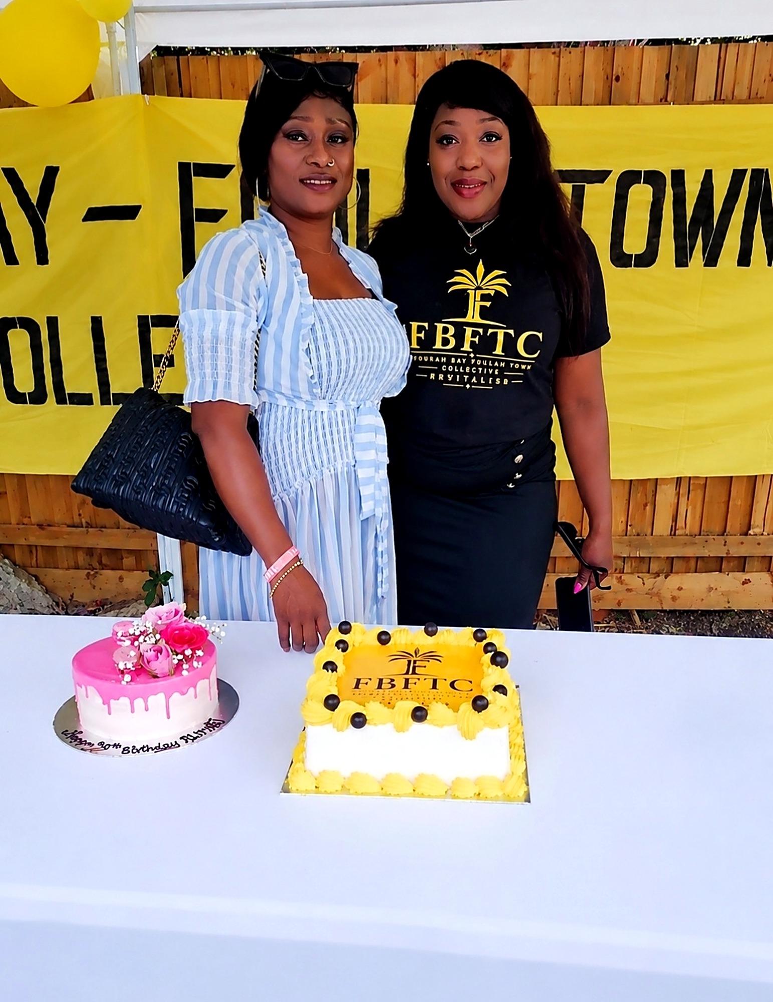 Members beside the FBFTC cake table